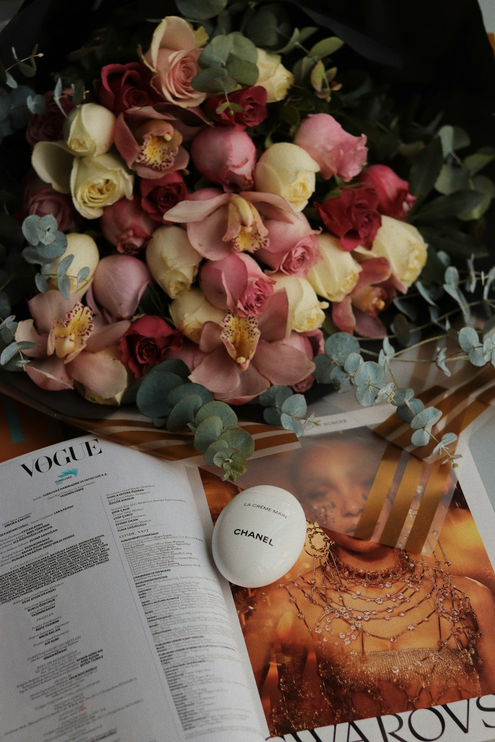 a bouquet of flowers sitting on top of a magazine