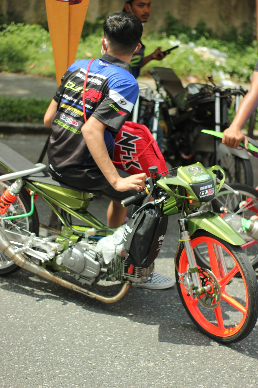 a man riding a motorcycle down a street