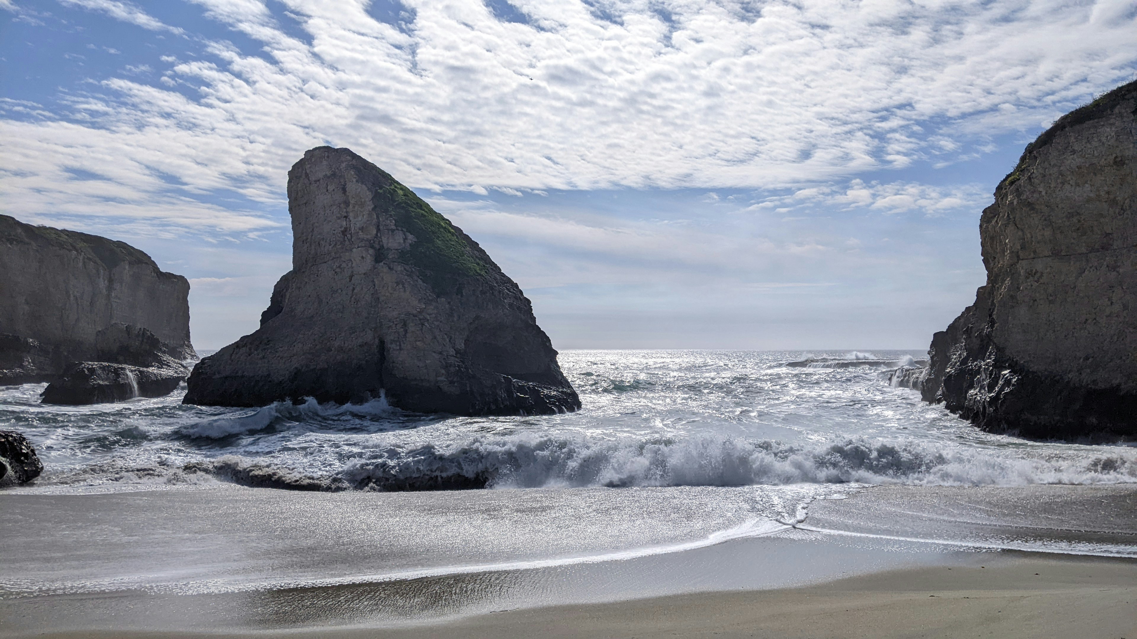 a couple of large rocks sitting on top of a beach