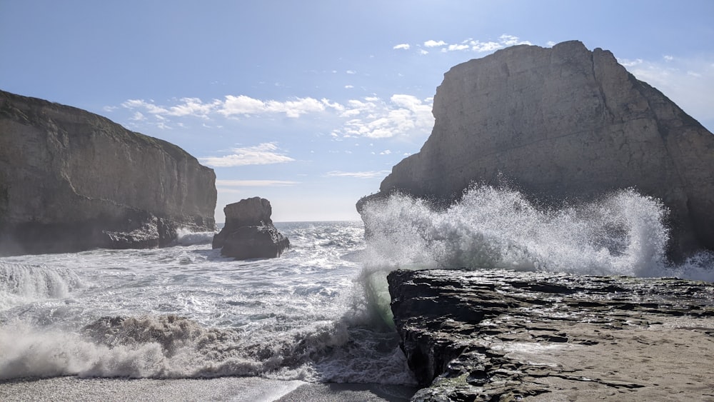 a large rock formation next to a body of water