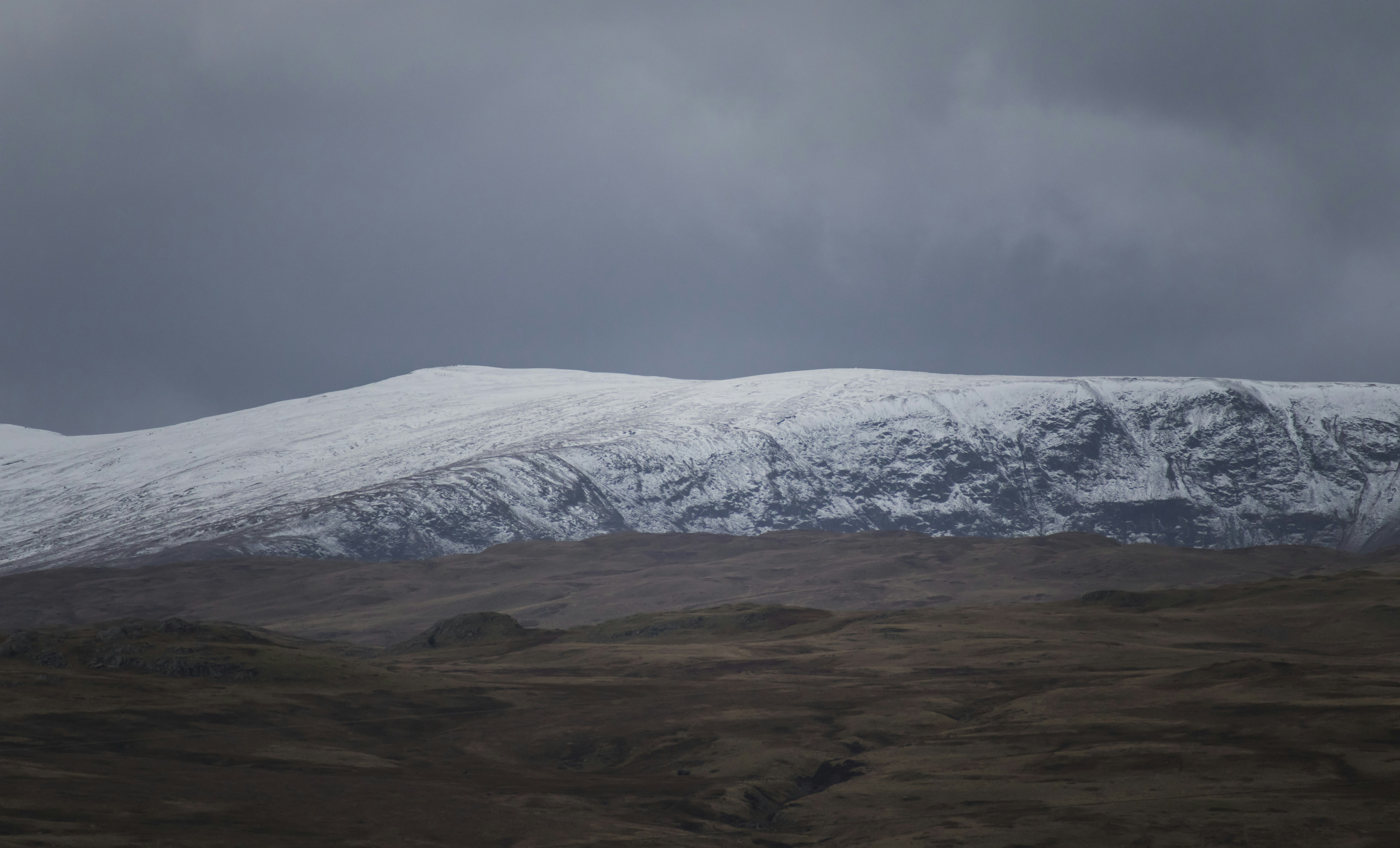 a mountain covered in snow on a cloudy day