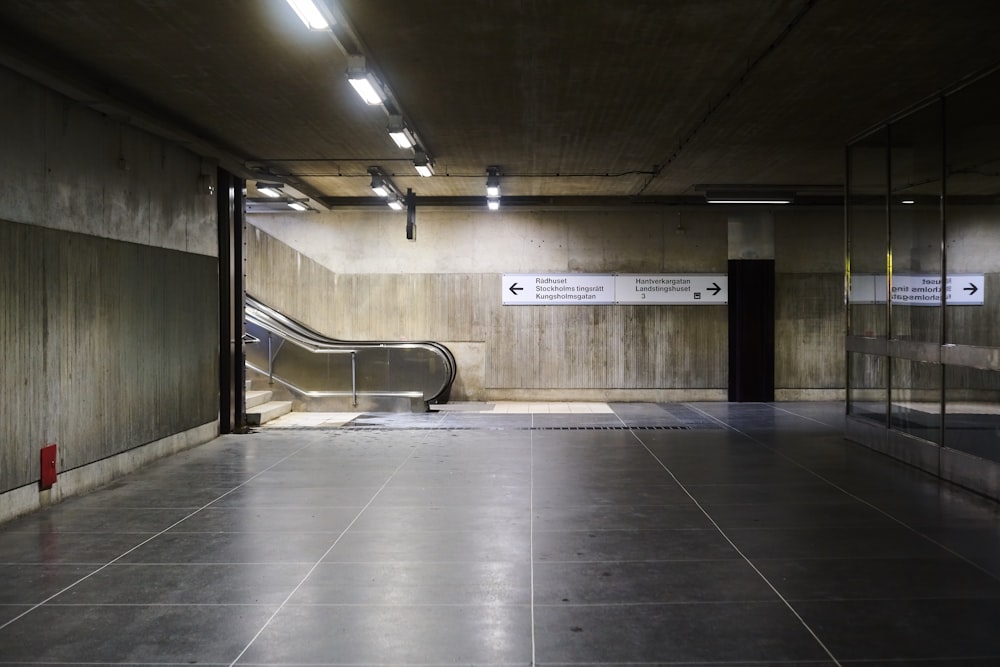 an empty parking garage with an escalator
