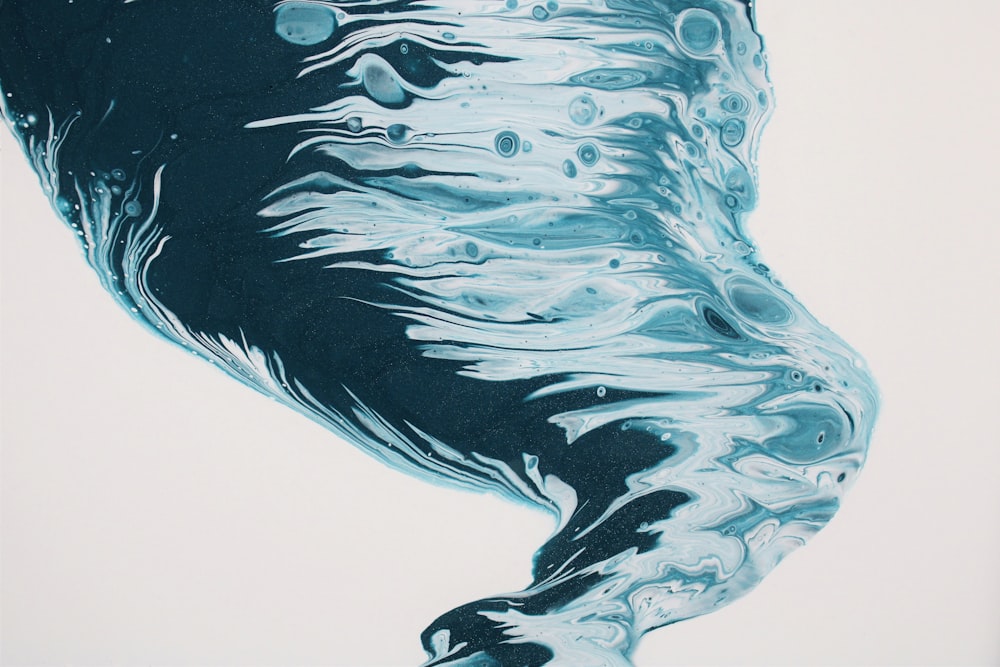 a painting of blue and black swirls on a white background