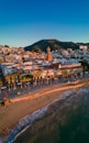 an aerial view of a beach with a city in the background