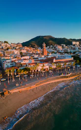 an aerial view of a beach with a city in the background