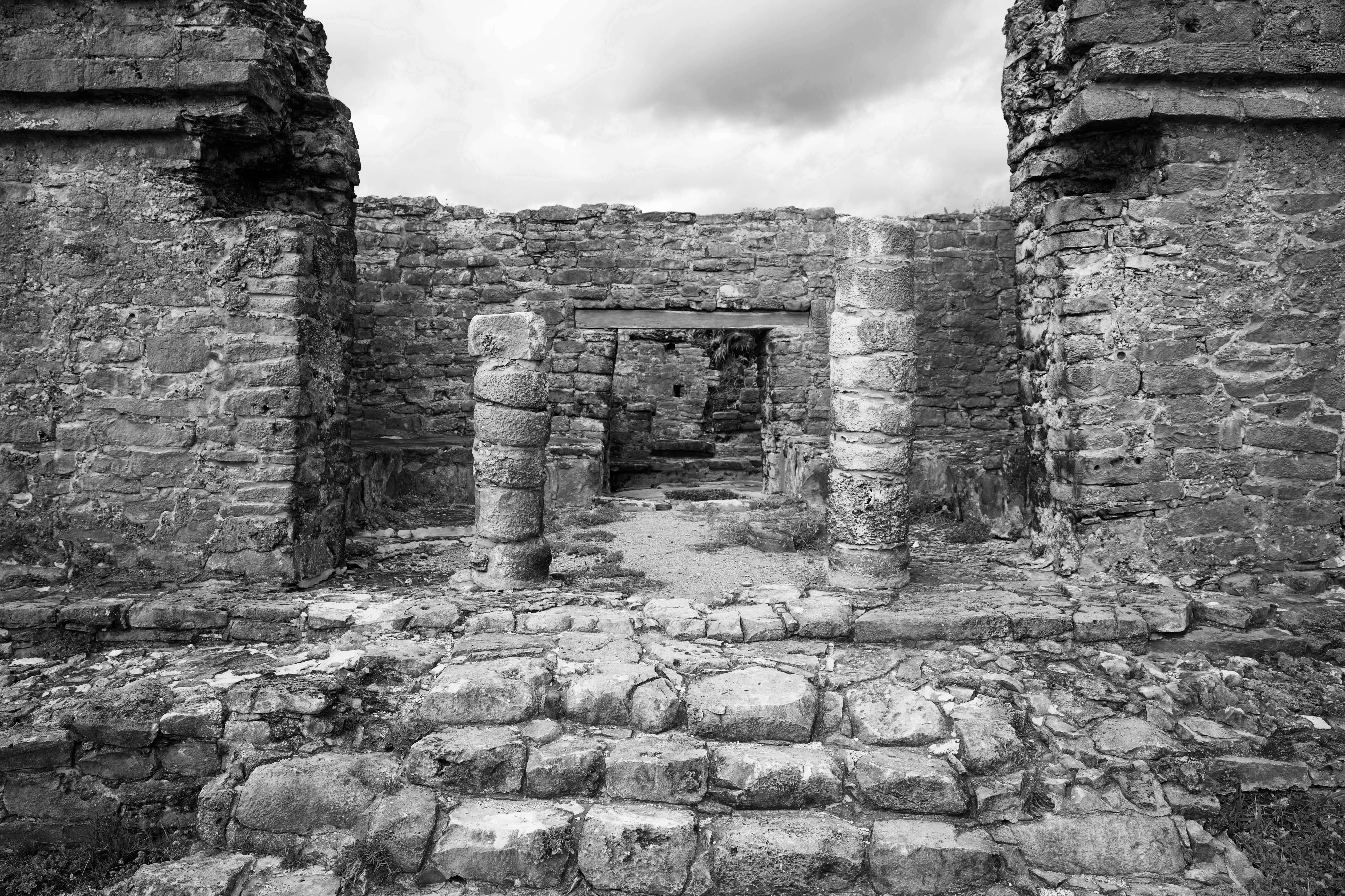 a black and white photo of a stone building, 