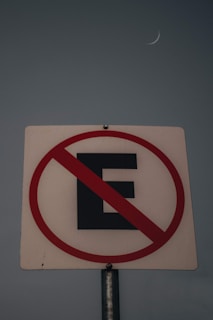 a street sign with a crescent in the background
