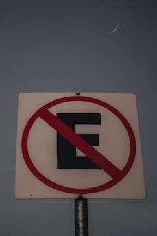 a street sign with a crescent in the background