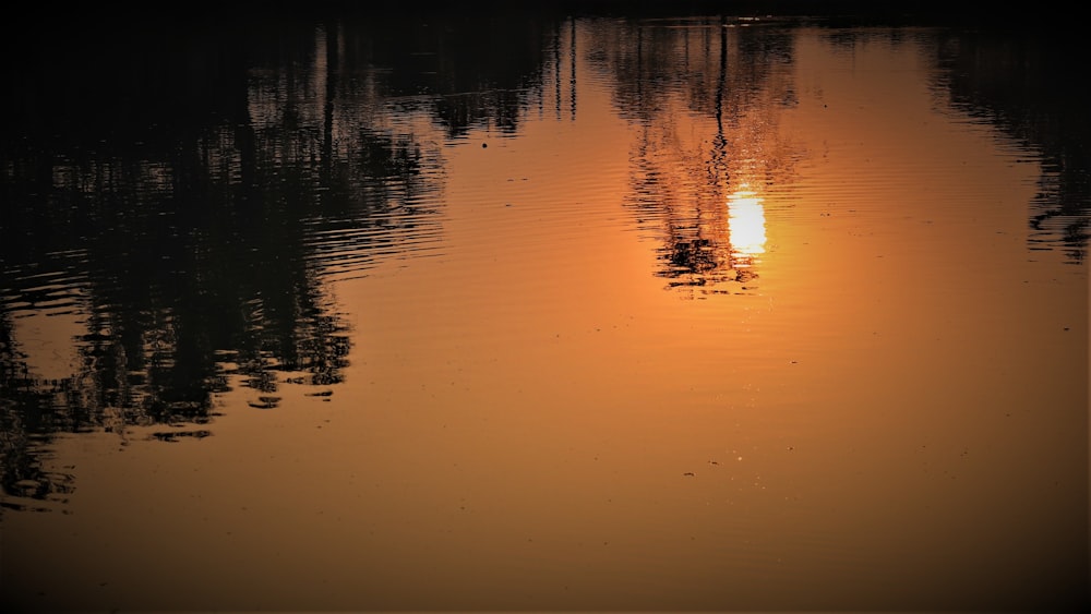 the sun is setting over a body of water