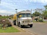 Fuel delivery being made to a driver stranded on a quiet suburban road.