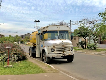 Vacuum truck cleaning a residential septic tank in a suburban area.