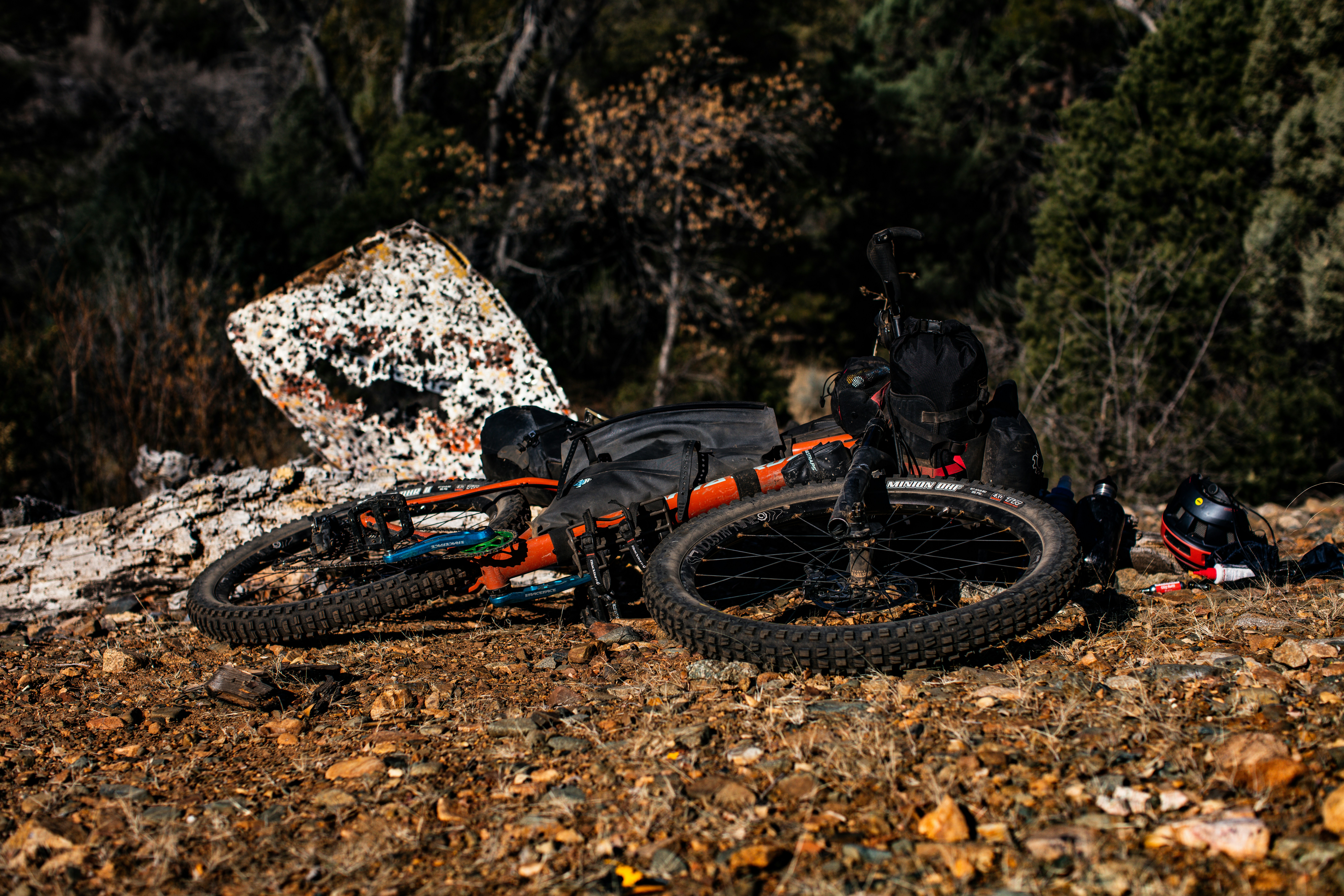 a bike is parked on the ground next to a rock