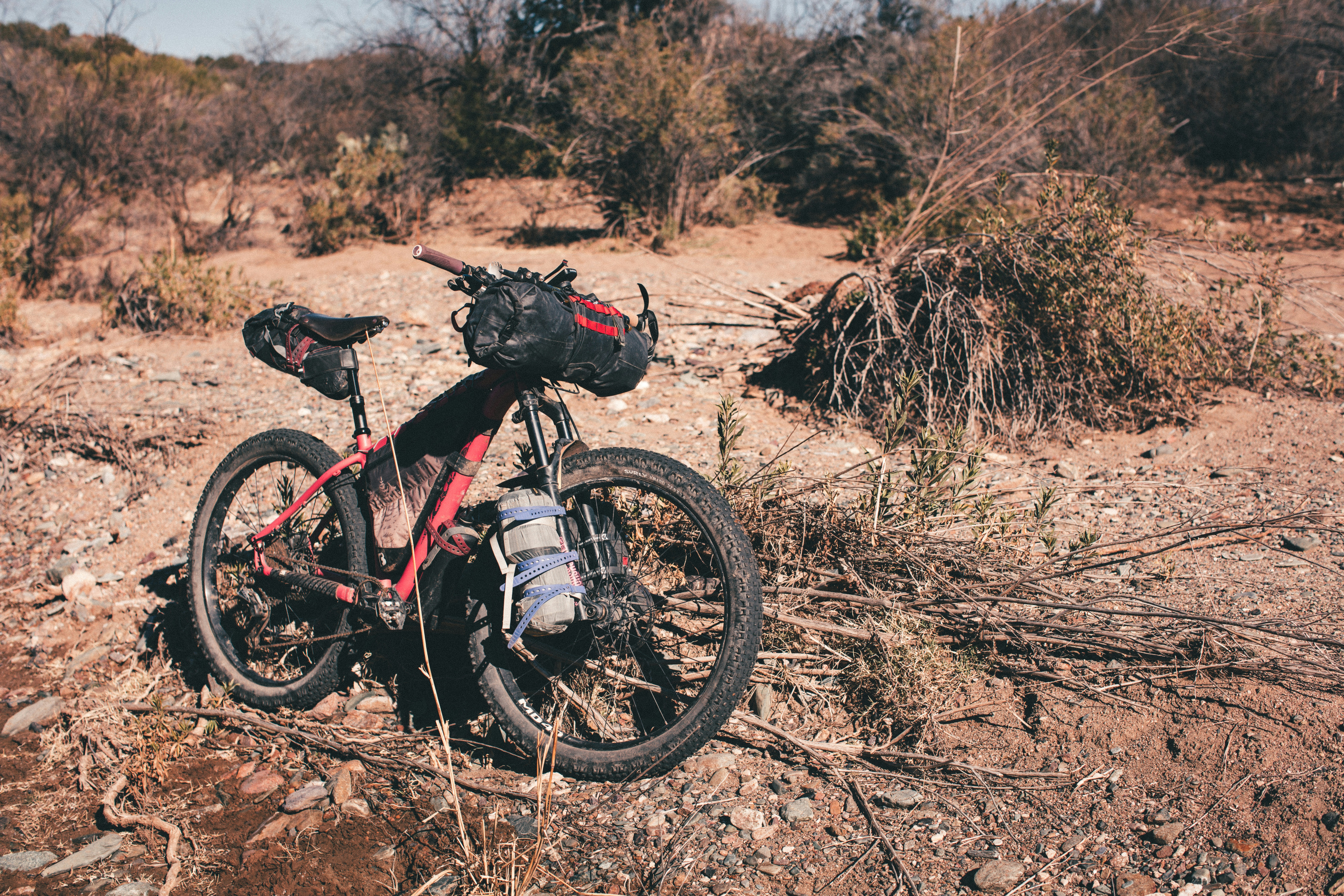 a bike with a helmet on it is parked in the dirt