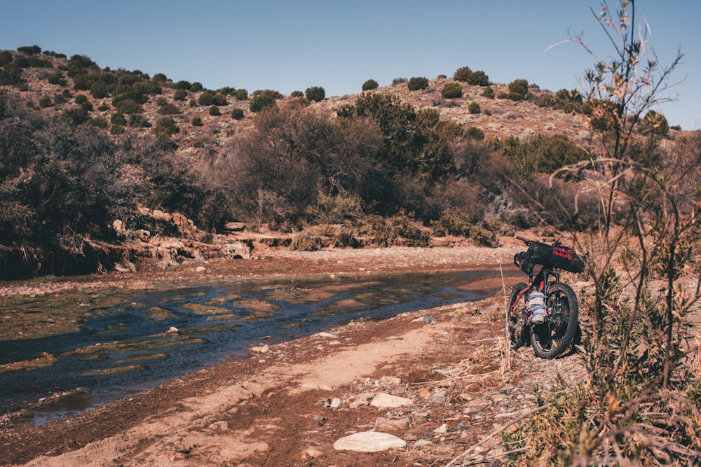 a motorcycle parked next to a body of water