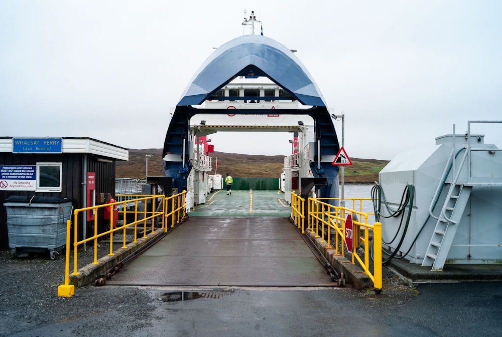 a boat dock with a blue and white boat