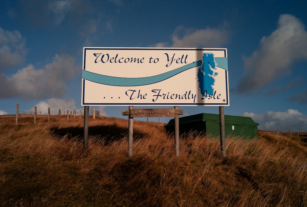 a welcome sign on the side of a hill