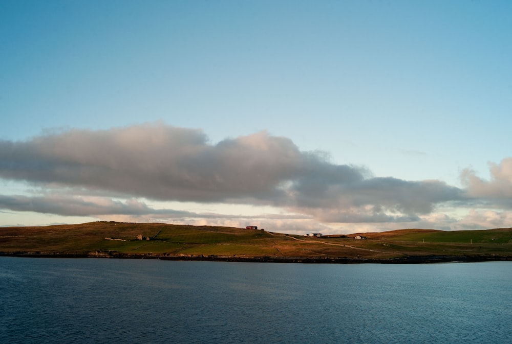 a large body of water sitting under a cloudy sky