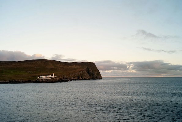 A lighthouse on a rocky outcrop — Shetland, United Kingdom
