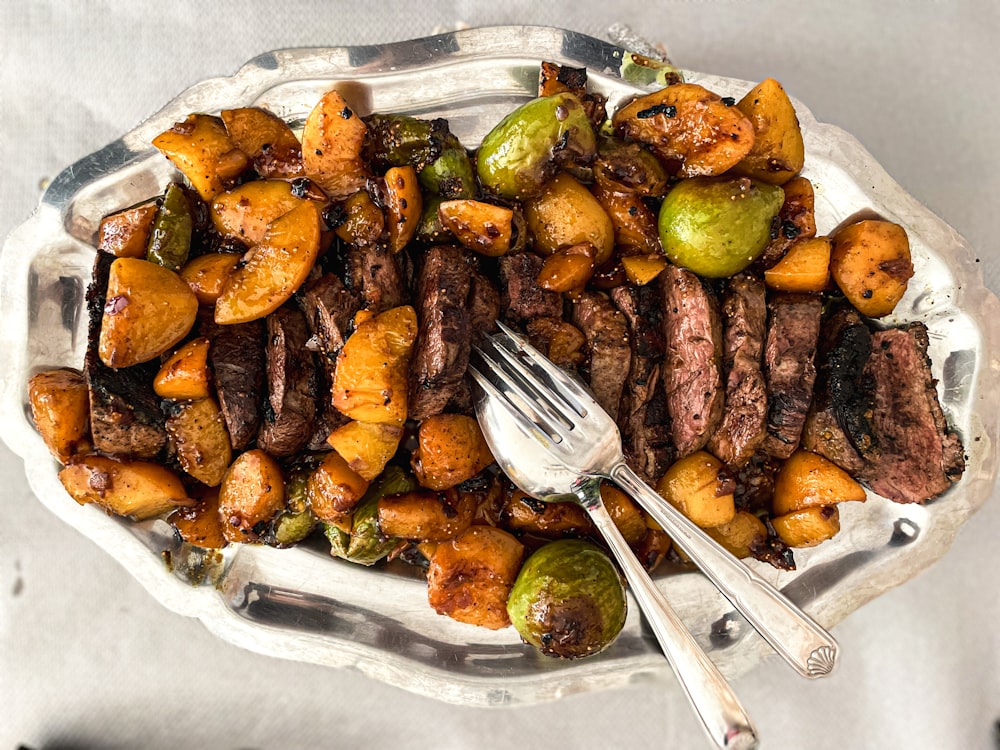 a plate of steak, brussel sprouts and brussels sprouts