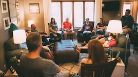 a group of people sitting in a living room together