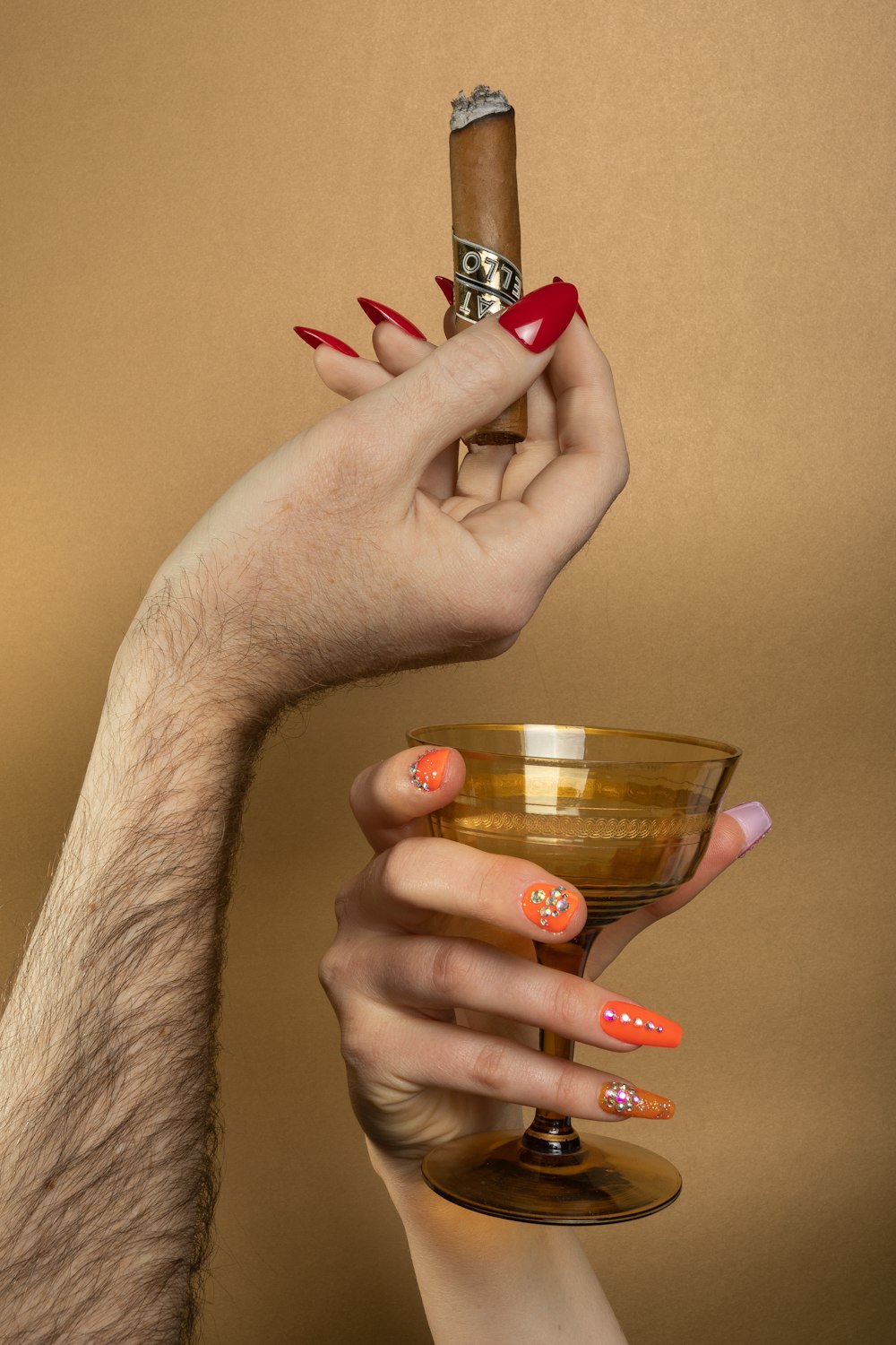 a woman holding a glass with a cigar in it