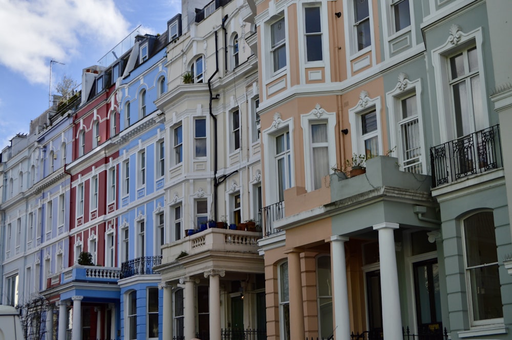 a row of multicolored buildings on a city street