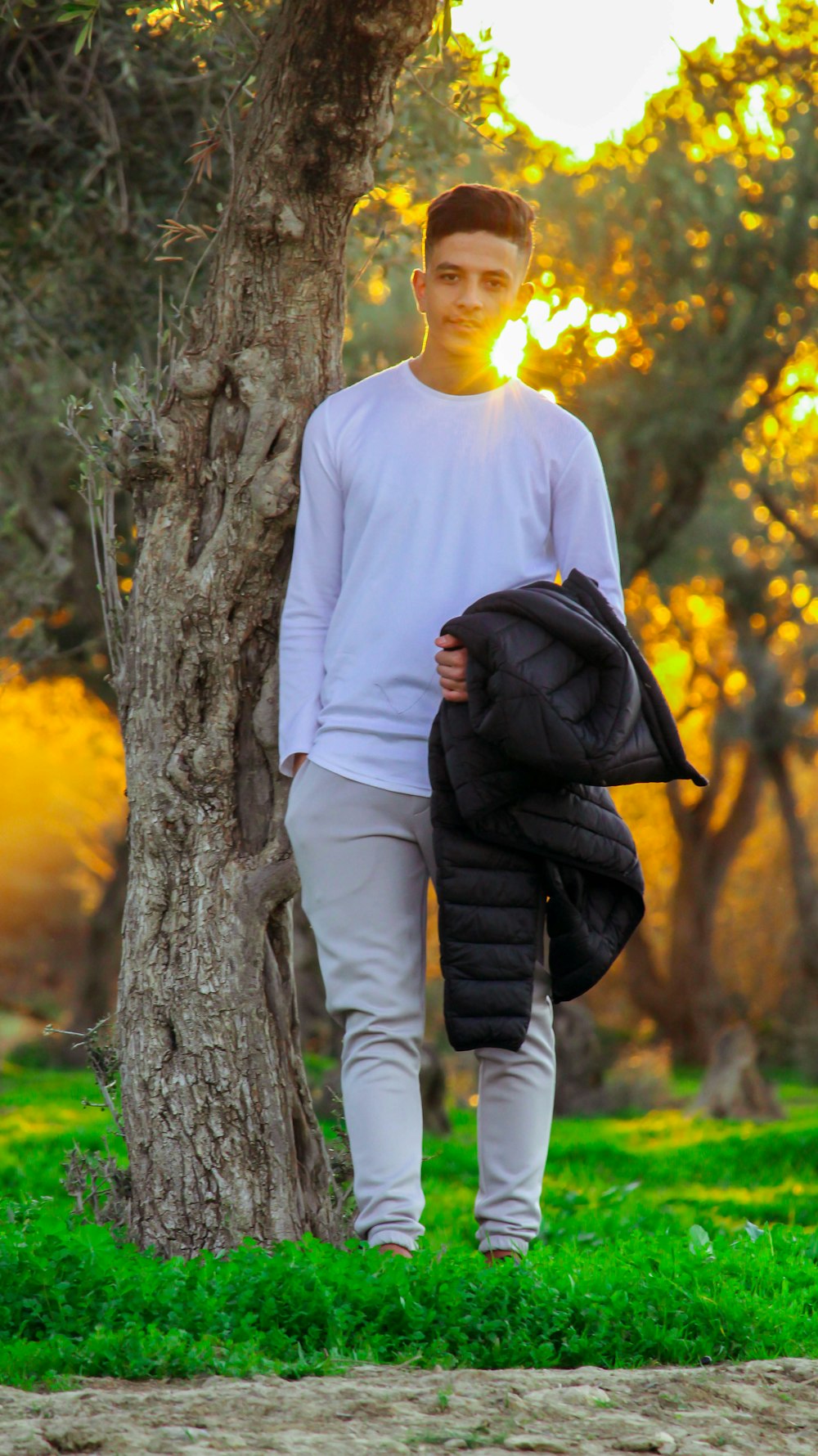 a young man is walking in the park