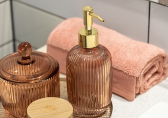 a bathroom sink with a soap dispenser and a soap dish