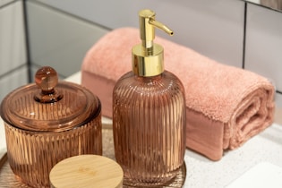 a bathroom sink with a soap dispenser and a soap dish