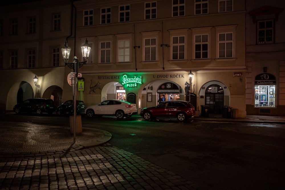 a couple of cars that are parked in front of a building