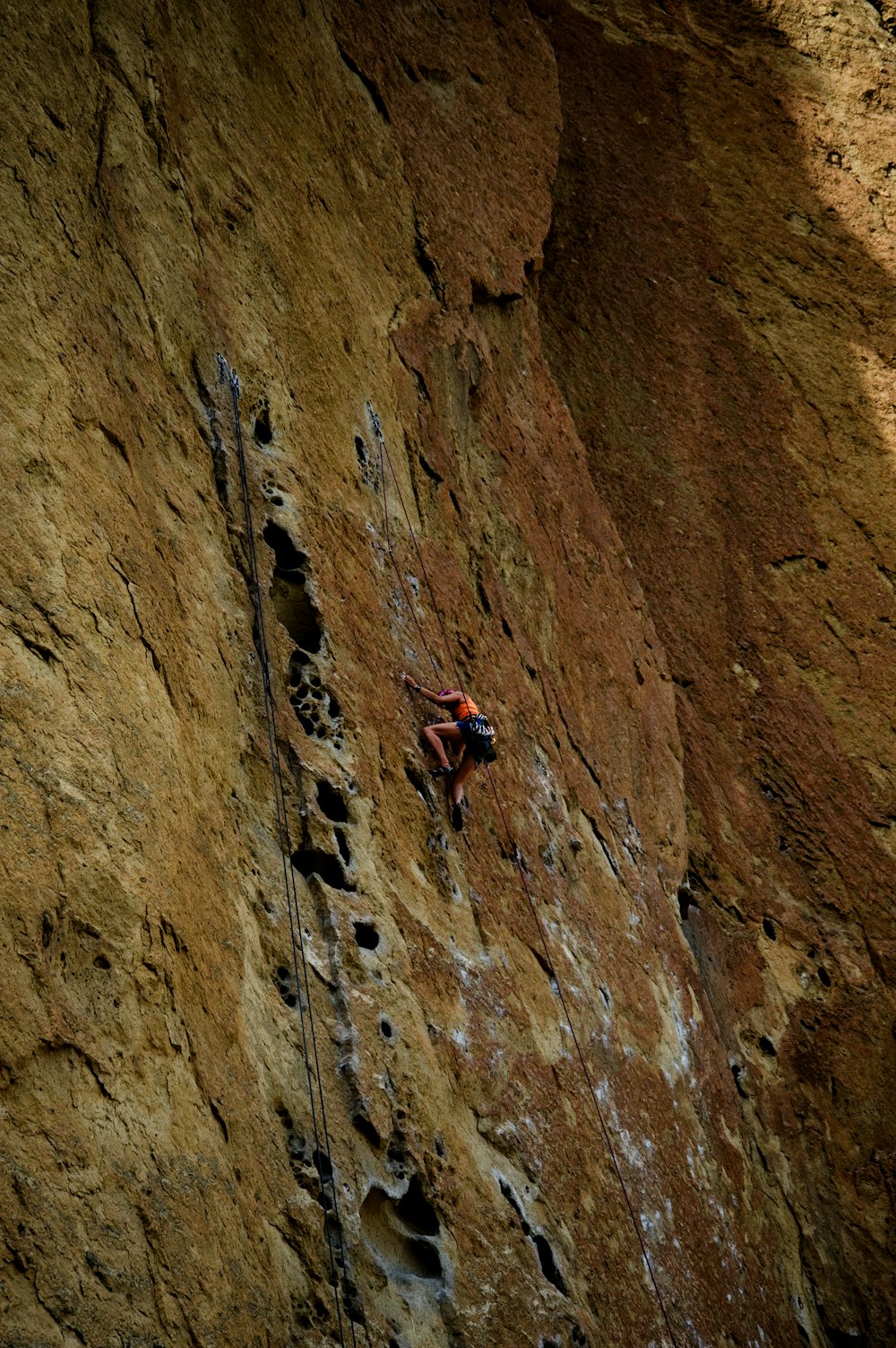 a man climbing up the side of a mountain