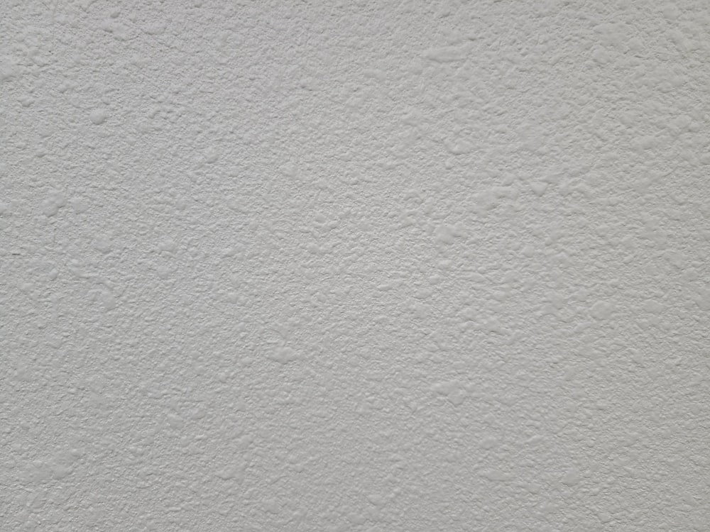 a close up of a white stucco wall