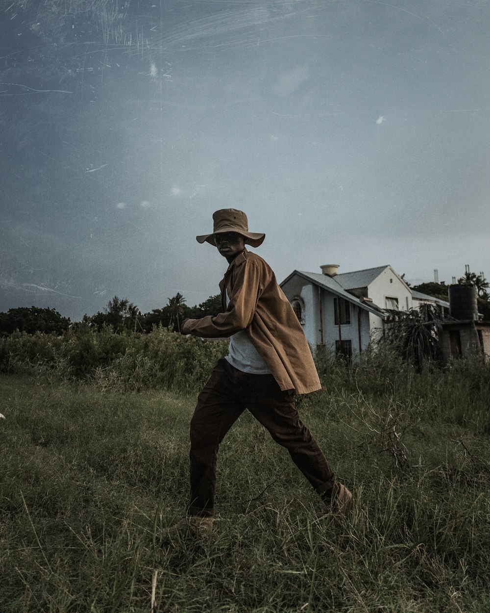 a man in a hat is in a field