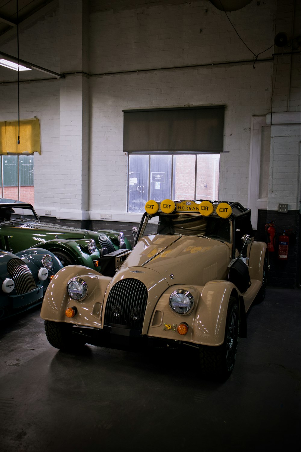 a row of old cars in a garage