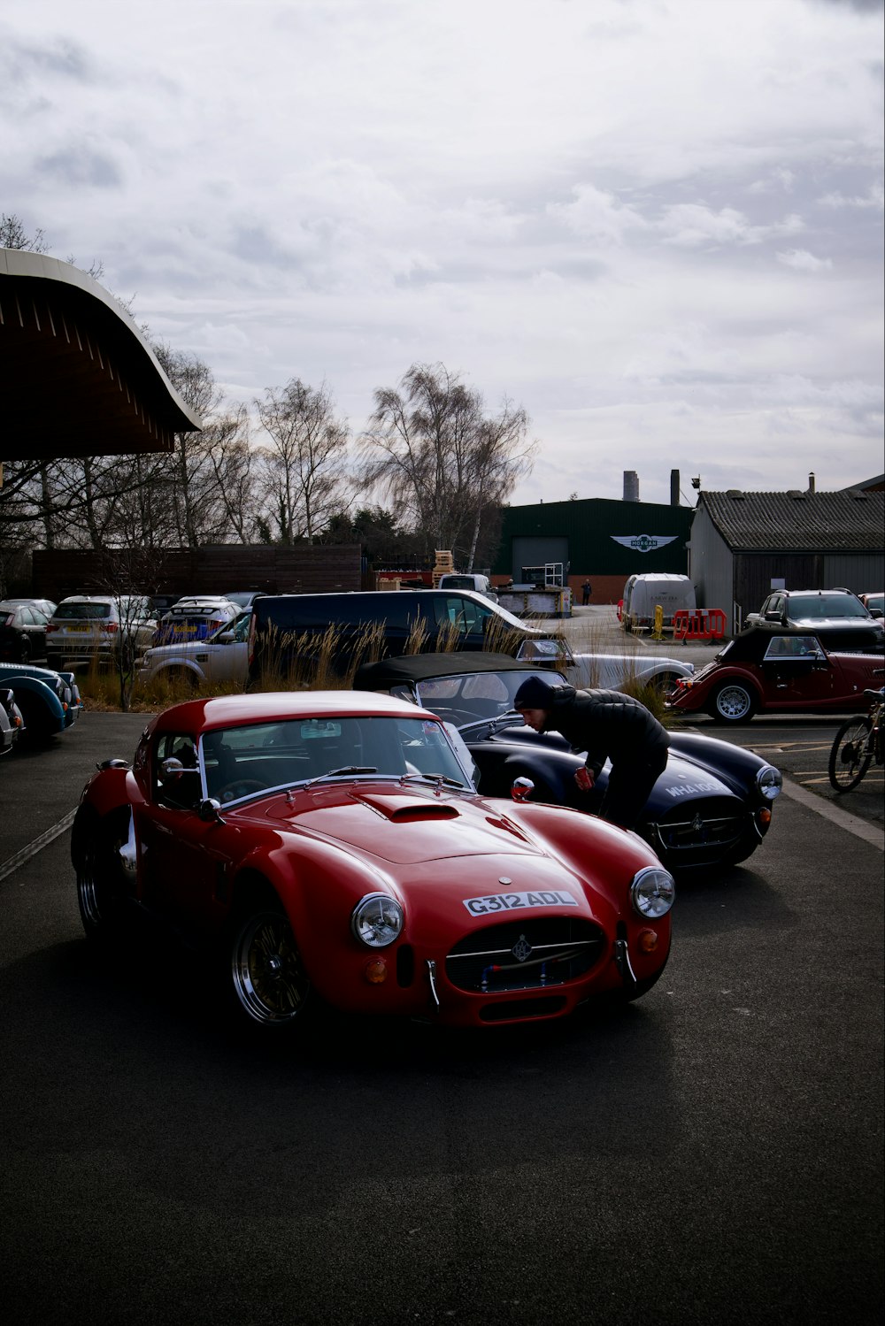 a red sports car parked in a parking lot