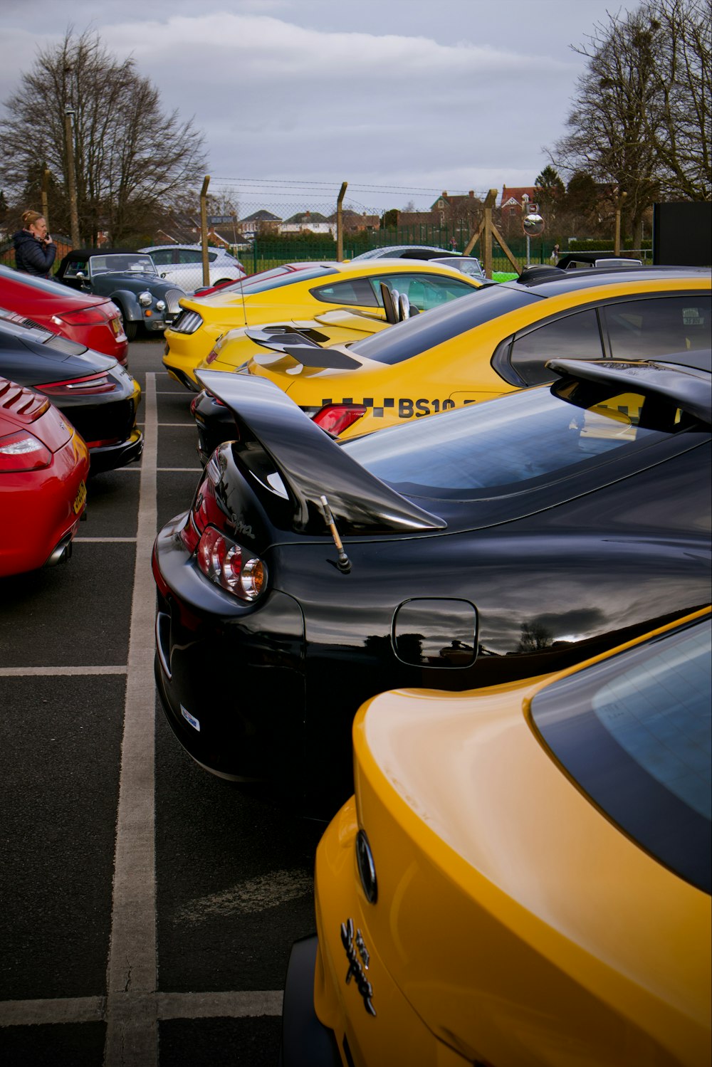 a row of parked cars in a parking lot