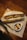 A sandwich filled with fried ingredients and vegetables is placed on a bamboo mat. Next to the sandwich is a small white dish containing a dark sauce with slices of garlic and chili.