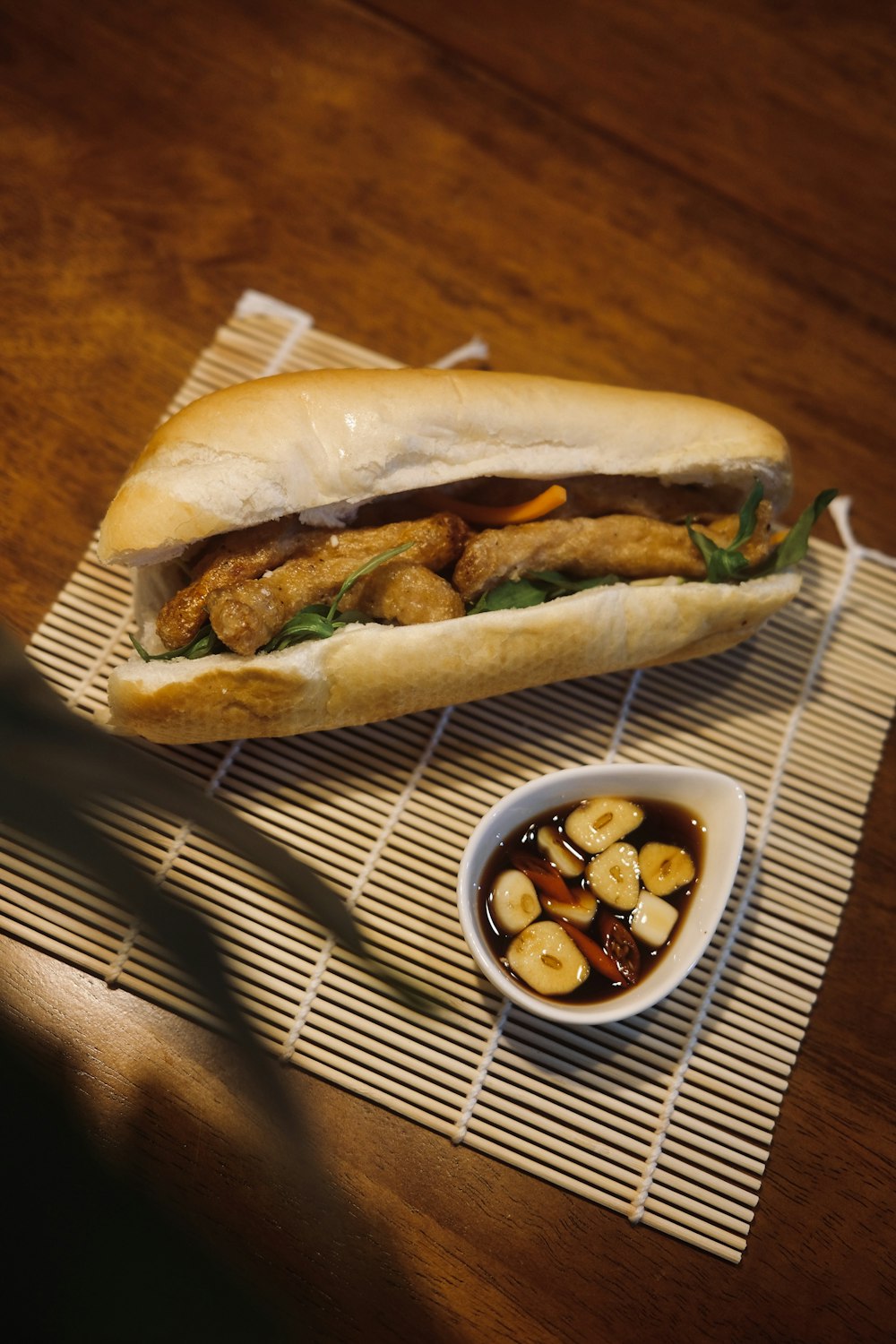 a sandwich and a bowl of food on a table