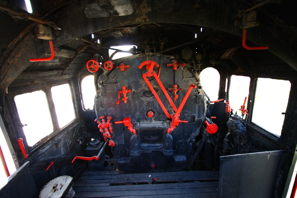 the inside of an old train car with red paint