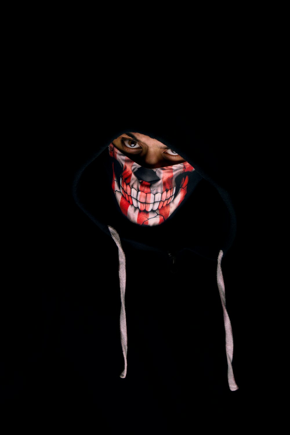 a person wearing a mask in the dark