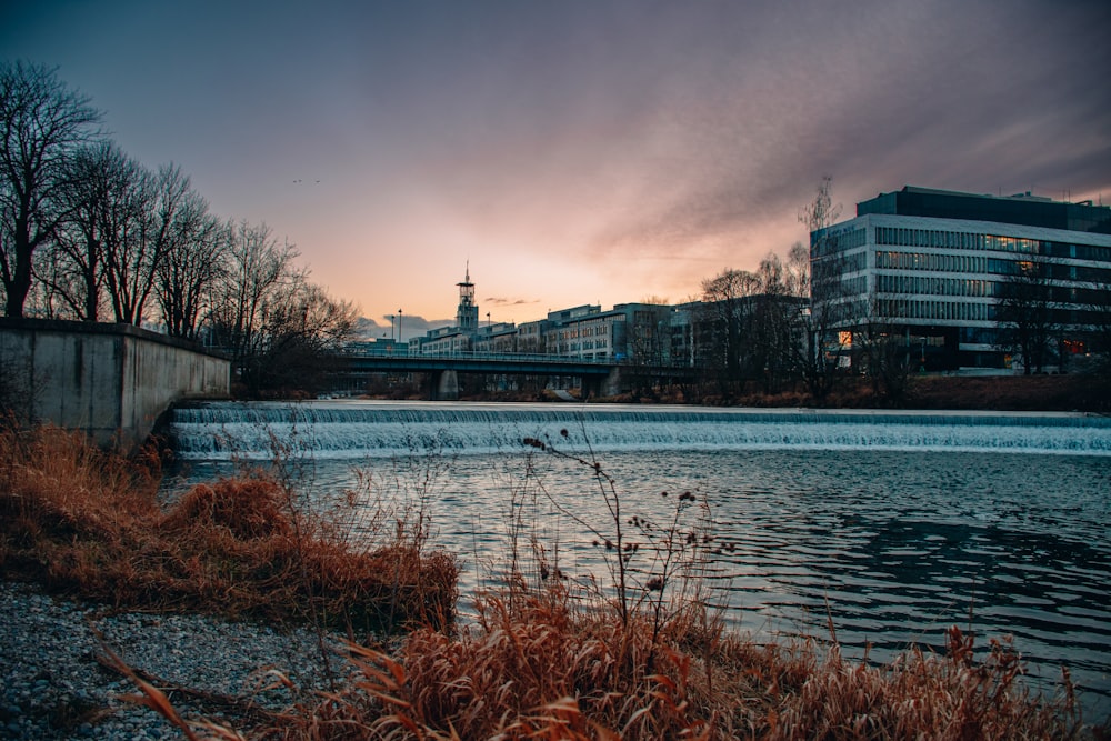 a body of water with a bridge in the background