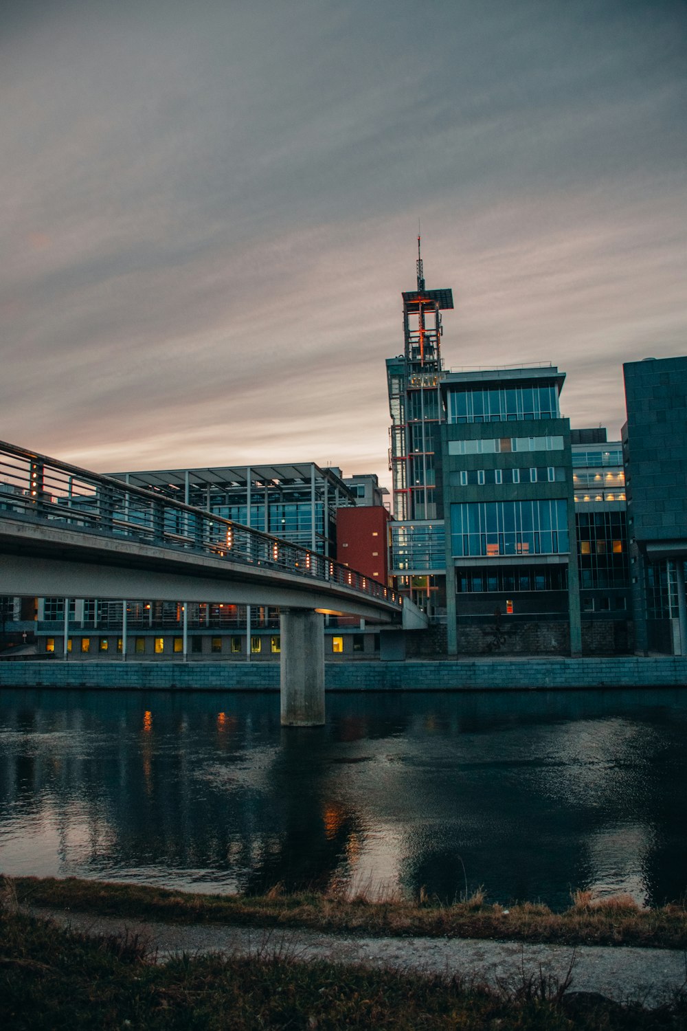 a bridge over a body of water with buildings in the background