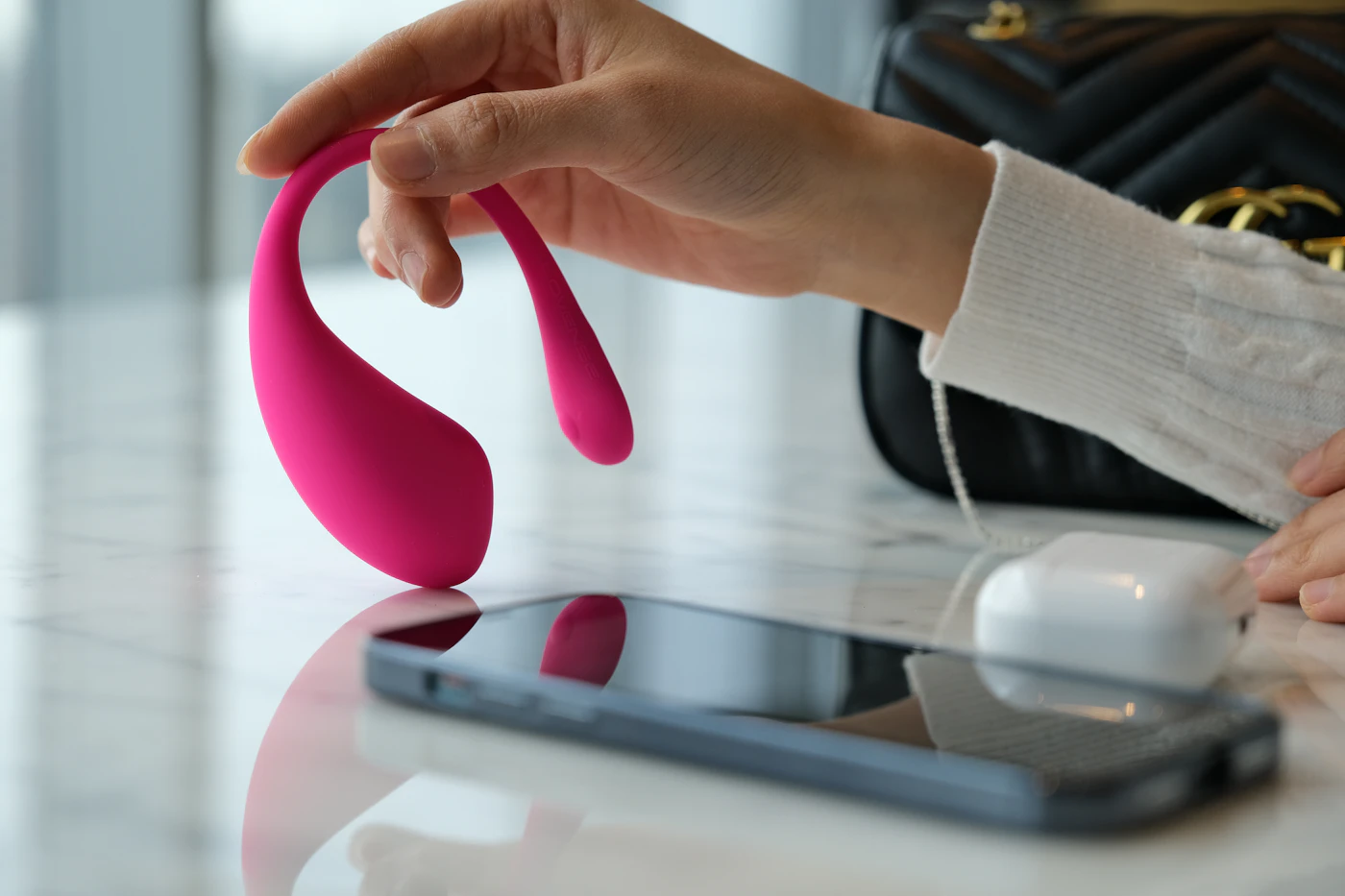 App-connected massager beside a smartphone