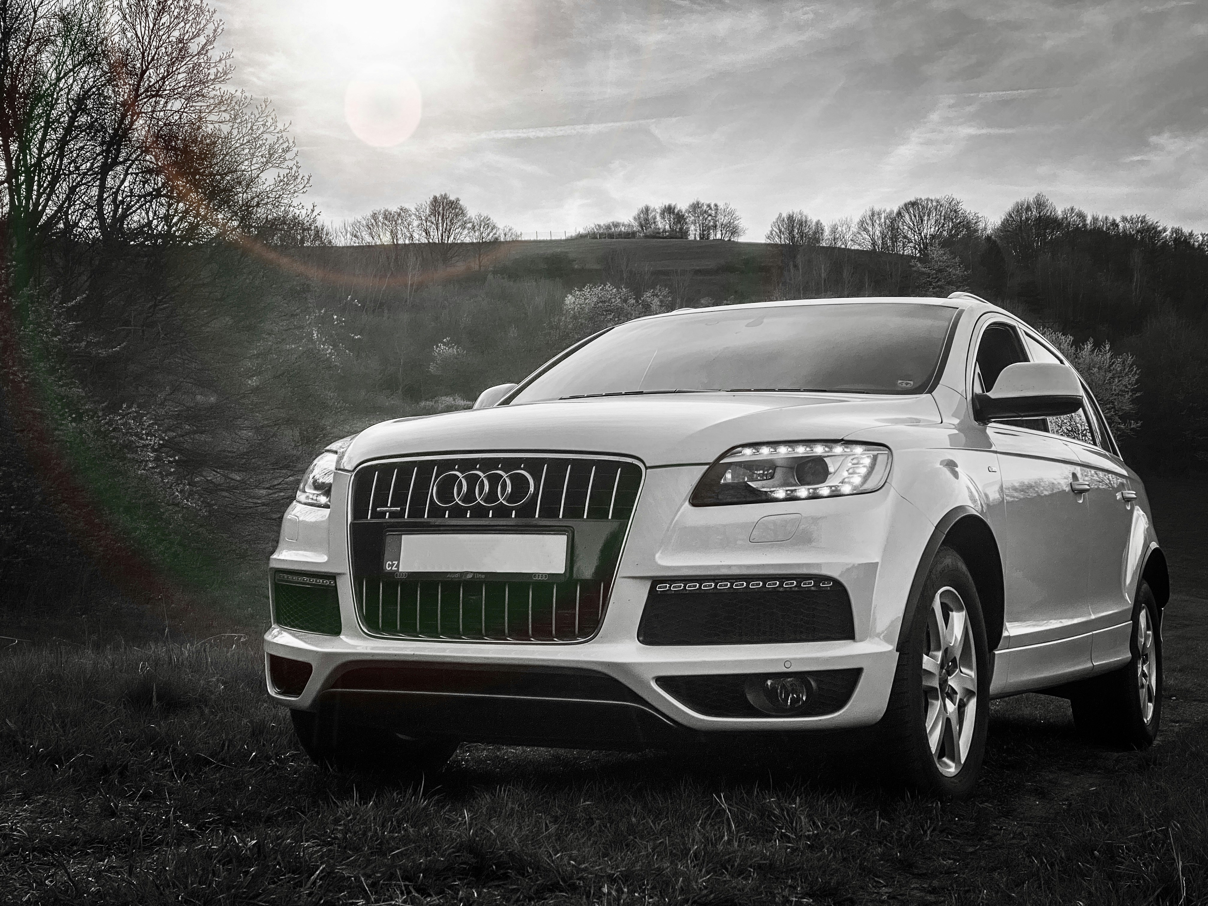 Audi Q7 full-size SUV in grey, family lifestyle setting, suburban driveway, morning light