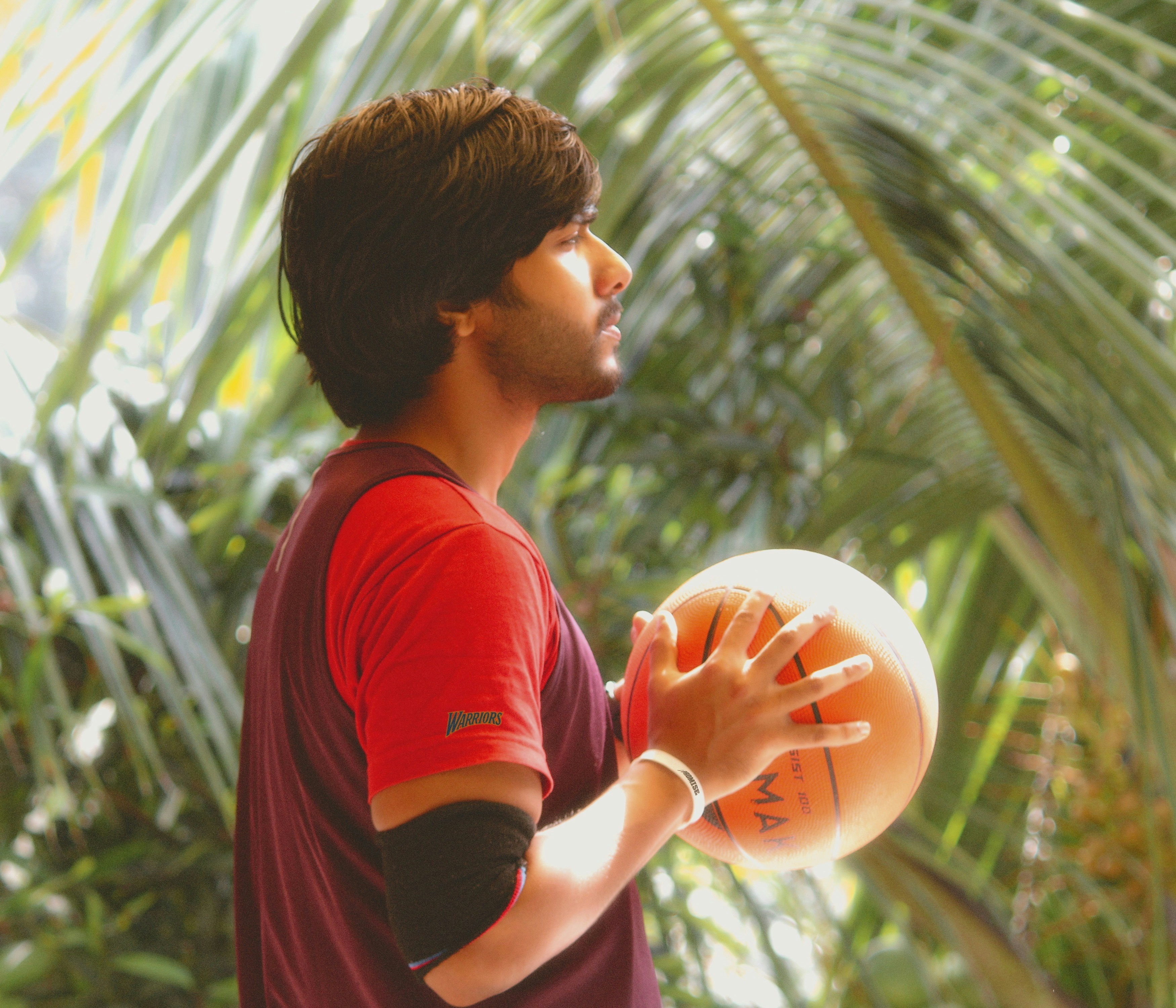 a man holding a basketball in his right hand