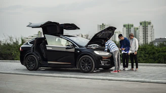 A friendly locksmith technician unlocking a car door with professional tools in a busy urban setting.