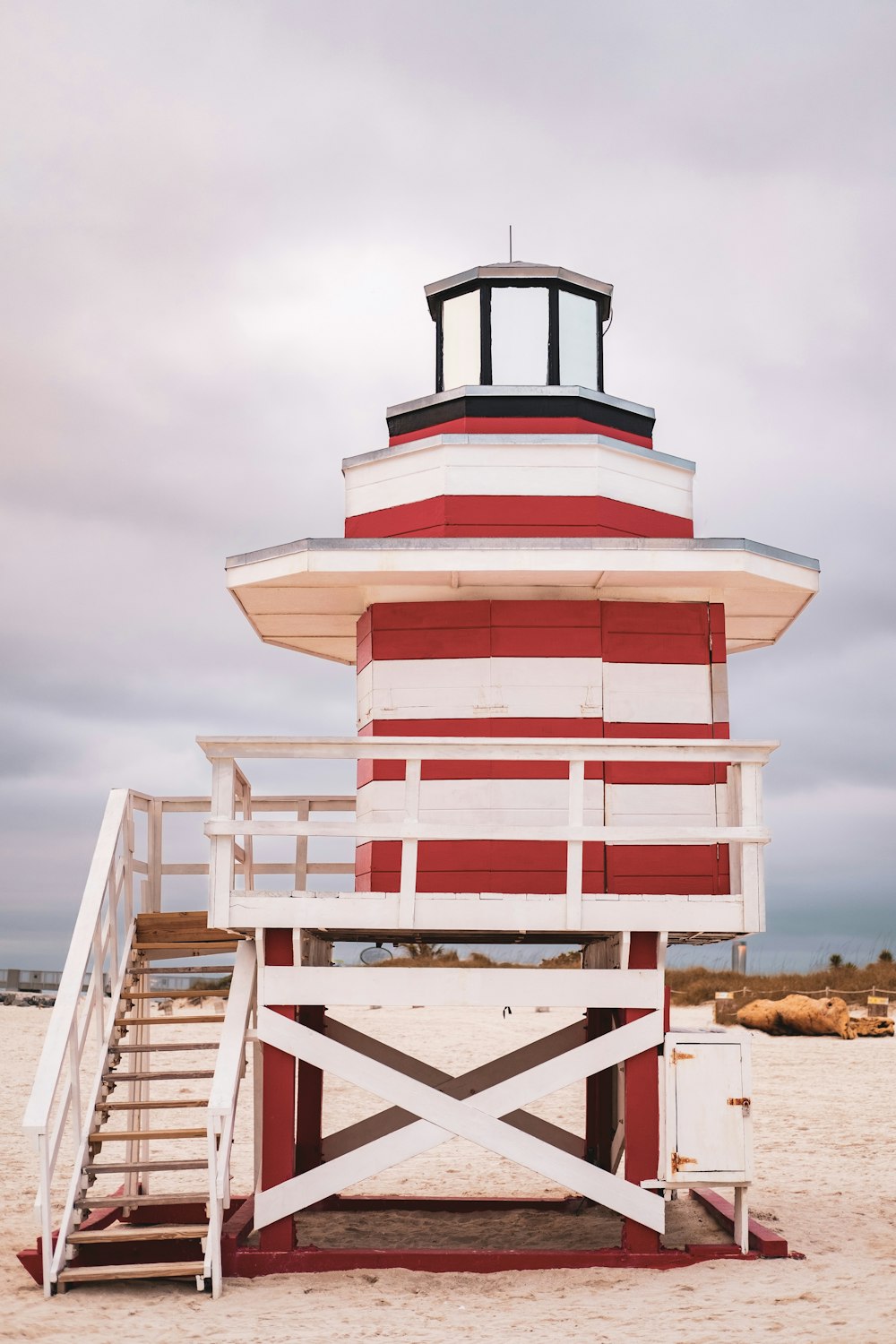 a lifeguard tower on the beach with stairs leading up to it