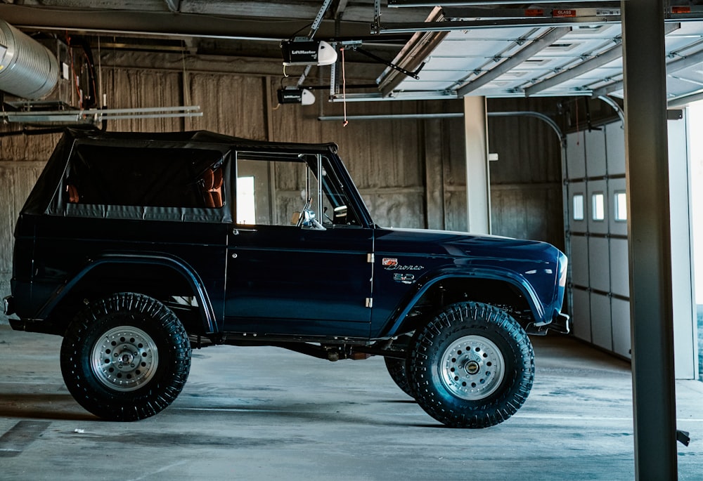 a blue truck parked inside of a garage