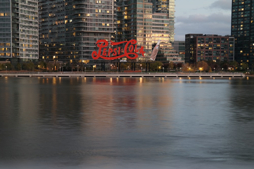 a body of water with buildings in the background