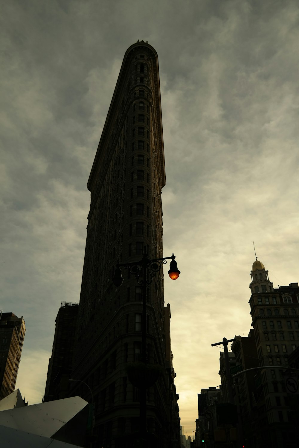 a very tall building with a street light in front of it